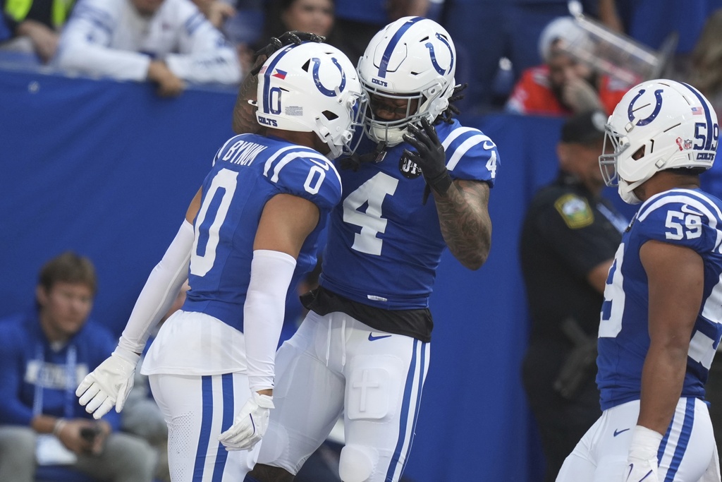 Indianapolis Colts safety Cam Bynum (0) celebrates an interception with teammate Colts cornerback Xavien Howard (4) during the first half of an NFL football game against the Miami Dolphins on Sunday, Sept. 7, 2025, in Indianapolis. (AP Photo/Darron Cummings)