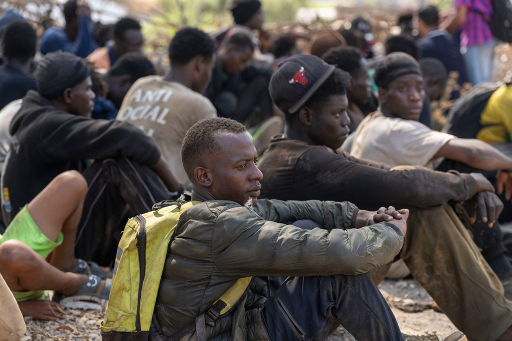 Migrants are detained by Moroccan security forces after attempting to cross from the border town of Fnideq to the Spanish enclave of Ceuta, Saturday, Aug. 15, 2026. (AP Photo)