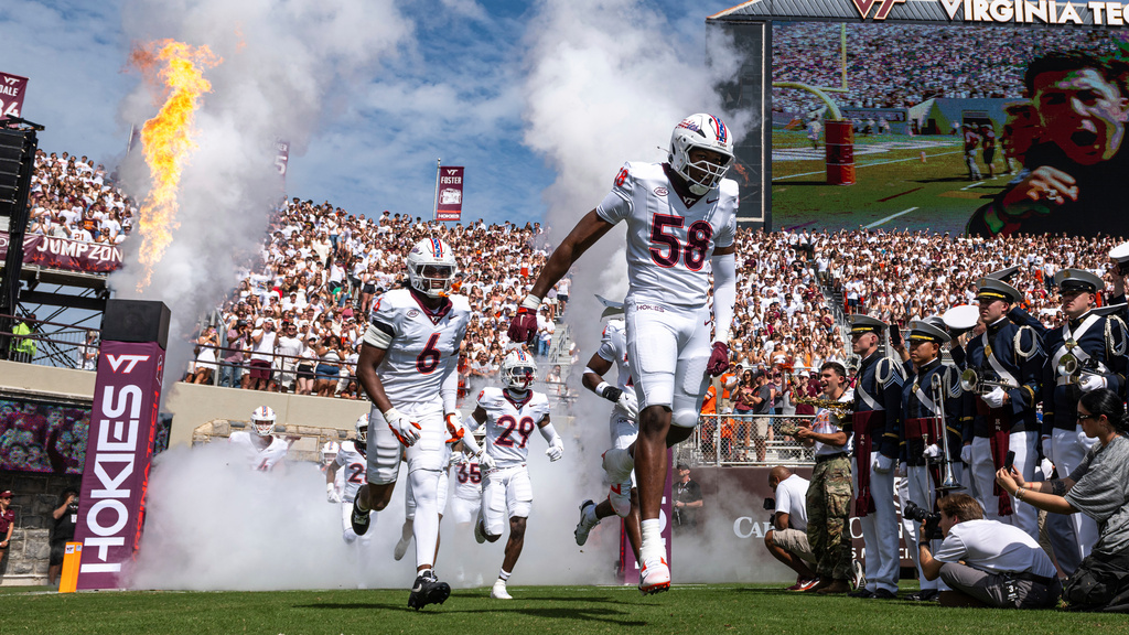 FILE - Virginia Tech players enter the Lane Stadium before the start of an NCAA college football game Saturday, Sept. 20 2025, in Blacksburg, Va. (AP Photo/Robert Simmons, File)