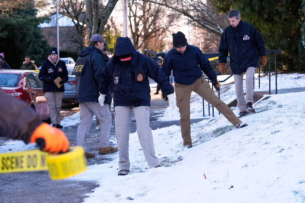 Members of the FBI Evidence Response Team search for evidence near the campus of Brown University, Monday, Dec. 15, 2025, in Providence, R.I. (AP Photo/Robert F. Bukaty)
