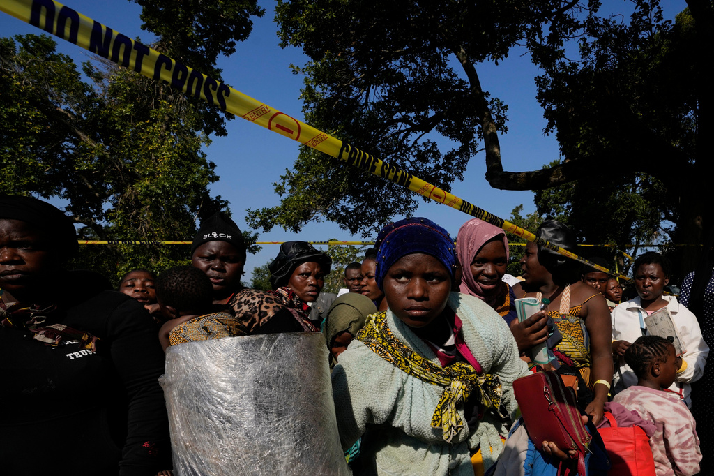 Malawian migrants stand in a queue for their deportation at a temporary centre, in South Africa, Thursday, June 18, 2026. (AP Photo/Themba Hadebe)