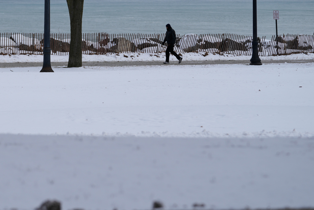 A person bundles up as take a walk during a cold weather day in Evanston, Ill., Thursday, Jan. 22, 2026. (AP Photo/Nam Y. Huh)