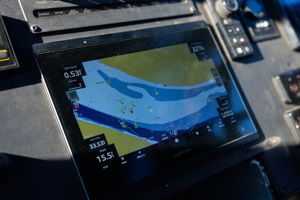Locations of debris from the collision of American Airlines Flight 5342 and an Army helicopter are displayed on the GPS screen as Metropolitan Police Department diver Jeffrey Leslie pilots a boat along the Potomac River, Thursday, Jan. 22, 2026, in Washington. (AP Photo/Julia Demaree Nikhinson)