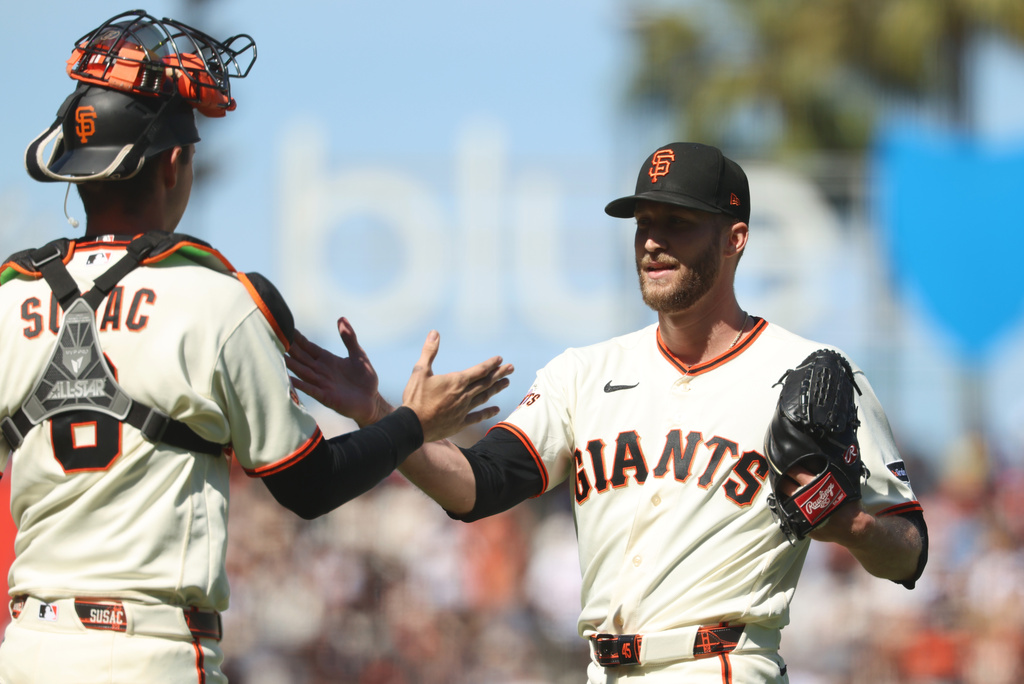 San Francisco Giants' Caleb Kilian, right, celebrates with Daniel Susac, left, after their team's victory over the Chicago White Sox in a baseball game in San Francisco, Sunday, May 24, 2026. (AP Photo/Jed Jacobsohn)