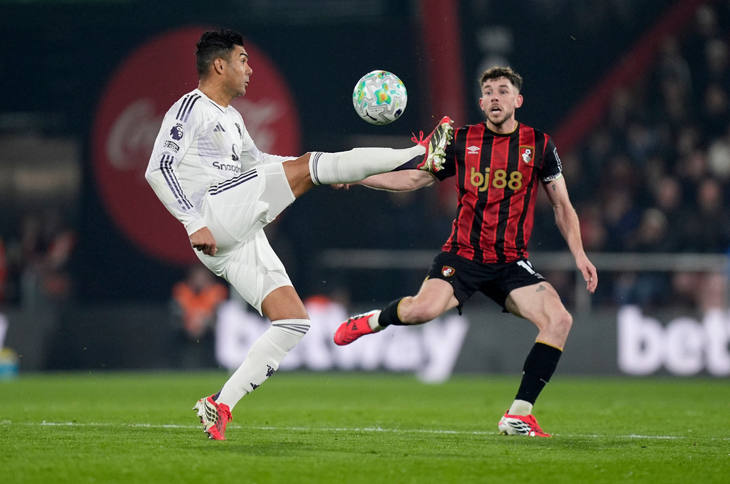 Manchester United's Casemiro, left, controls the ball in front of and Bournemouth's Ryan Christie during an Premier League soccer match, Friday, March 20, 2026, in Bournemouth, England. (Andrew Matthews/PA via AP)