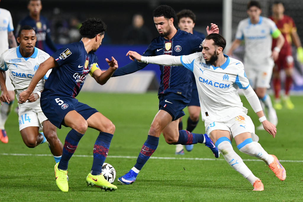 Marseille's Amine Gouiri, right, and PSG's Marquinhos, left. battle for the ball during the French Super Cup soccer match between PSG and Marseille in Kuwait City, Kuwait, Thursday, Jan. 8, 2026. (AP Photo/Jaber Abdulkhaleg)