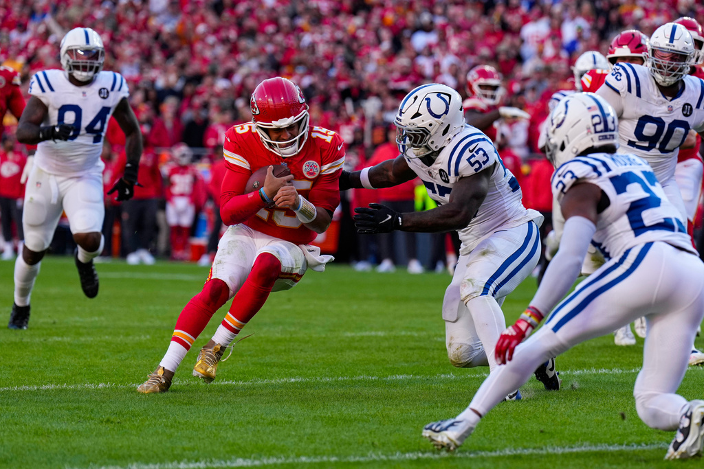 Kansas City Chiefs quarterback Patrick Mahomes (15) is tackled by Indianapolis Colts linebacker Germaine Pratt (53) during the second half of an NFL football game Sunday, Nov. 23, 2025, in Kansas City, Mo. (AP Photo/Charlie Riedel)