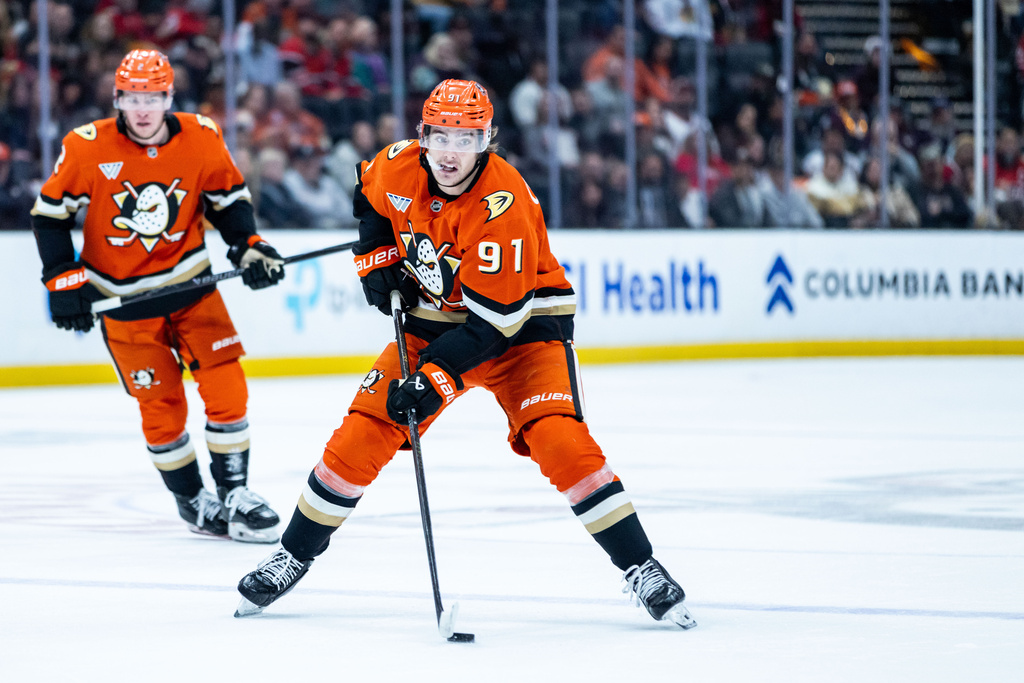 Anaheim Ducks center Leo Carlsson (91) controls the puck against the Chicago Blackhawks during the first period of an NHL hockey game Sunday, Dec. 7, 2025, in Anaheim, Calif. (AP Photo/Ethan Swope)