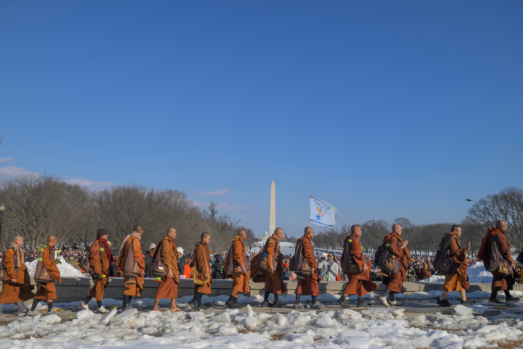 Buddhist monks who are participating in a Walk for Peace, walk near the Lincoln Memorial, in Washington, Wednesday, Feb., 11, 2026. (AP Photo/Rod Lamkey, Jr.)