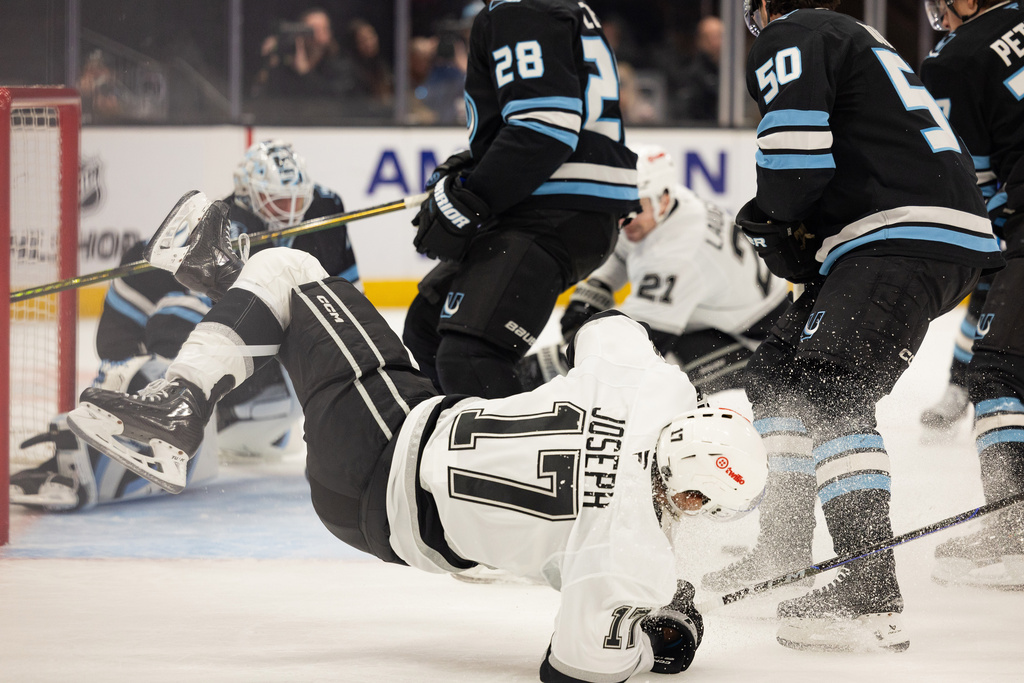 Los Angeles Kings right wing Mathieu Joseph (17) lands on the ice after getting block by the Utah Mammoth during the second period of an NHL hockey game, Sunday, March 22, 2026, in Salt Lake City. (AP Photo/Melissa Majchrzak)