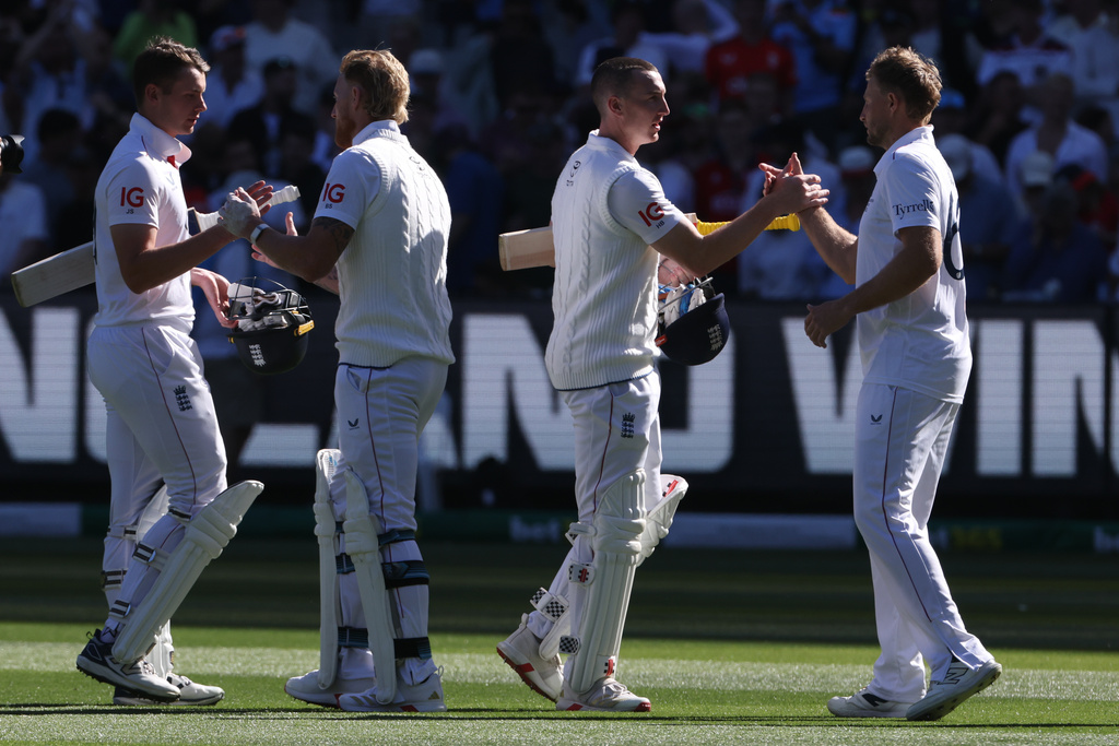 England's Jamie Smith, left, Ben Stokes, second left, Harry Brook andJoe Root, right, shake hands after defeating Australia on Day 2 of their Ashes cricket test match in Melbourne, Saturday, Dec. 27, 2025. (AP Photo/Hamish Blair)