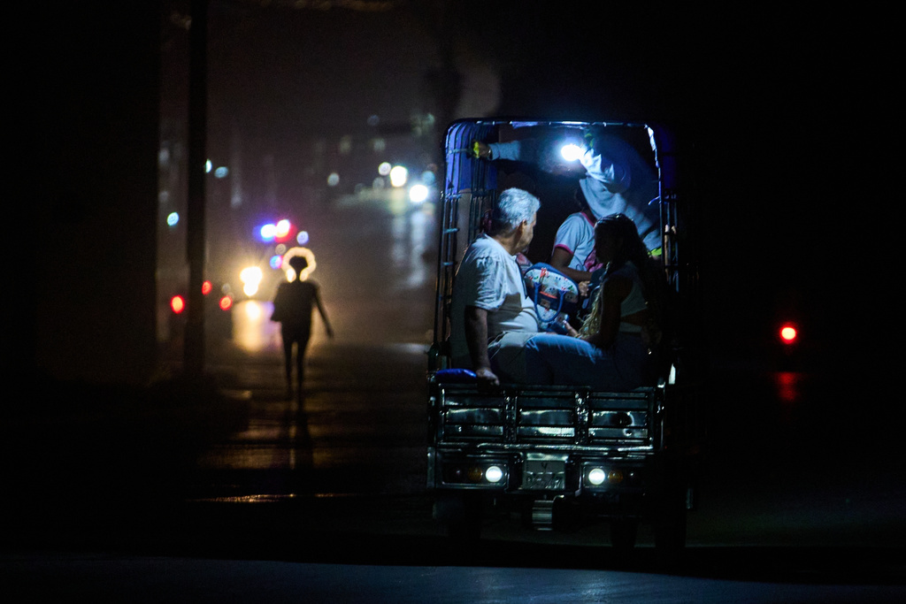 An electric tricycle transports customers during a blackout in Havana, Cuba, Saturday, March 21, 2026. (AP Photo/Ramon Espinosa)