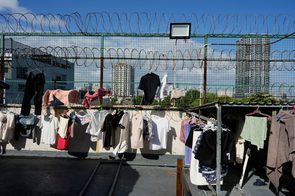 Clothes from rescued scam workers hang outside their rooms at the Presidential Anti-Organized Crime Commission temporary detention center, a former scam compound in Pasay, Philippines, Tuesday, June 3, 2025. (AP Photo/Aaron Favila)