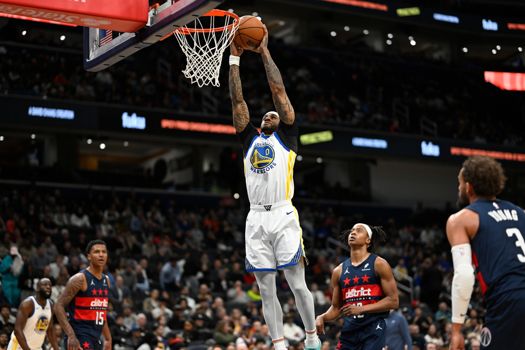 Golden State Warriors guard Gary Payton II (0) attempts a dunk during the first half of an NBA basketball game against the Washington Wizards, Monday, March 16, 2026, in Washington. (AP Photo/John McDonnell)