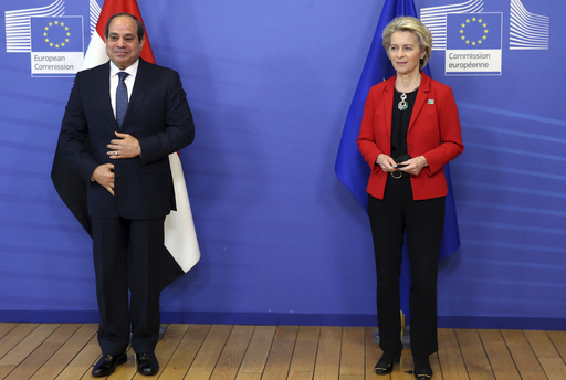 FILE - European Commission President Ursula von der Leyen, right, and Egypt's President Abdel Fattah El-Sisi pose for the media prior to a meeting on the sidelines of an EU Africa summit in Brussels, Thursday, Feb. 17, 2022. The European Union on Sunday, March 17, 2024, announced a $8 billion aid package for cash-strapped Egypt as concerns mount that economic pressure and conflicts in neighboring countries could drive more migrants to European shores. The deal is scheduled to be signed during a visit Sunday by European Commission President Ursula von der Leyen and leaders of Belgium, Italy, Austria, Cyprus and Greece, according to Egyptian officials.(Francois Walschaerts, Pool Photo via AP, File)