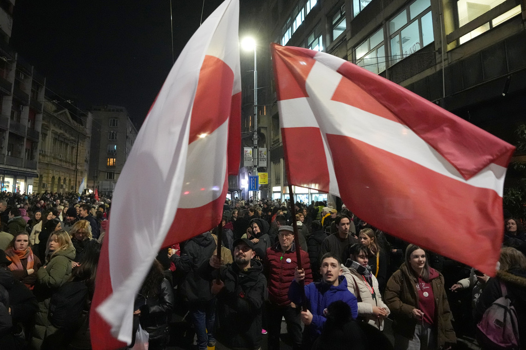 People wave a Greenland and Danish flags during a protest against a government crackdown on universities that have been a main force behind more than a year of protests shaking autocratic President Aleksandar Vucic's rule, in Belgrade, Serbia, Tuesday, Jan. 27, 2026. (AP Photo/Darko Vojinovic)