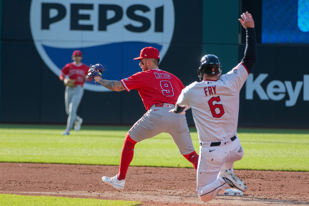 Los Angeles Angels' Zach Neto (9) forces out Cleveland Guardians' David Fry (6) at second base during the second inning of a baseball game, Monday, May 11, 2026, in Cleveland. (AP Photo/Phil Long)