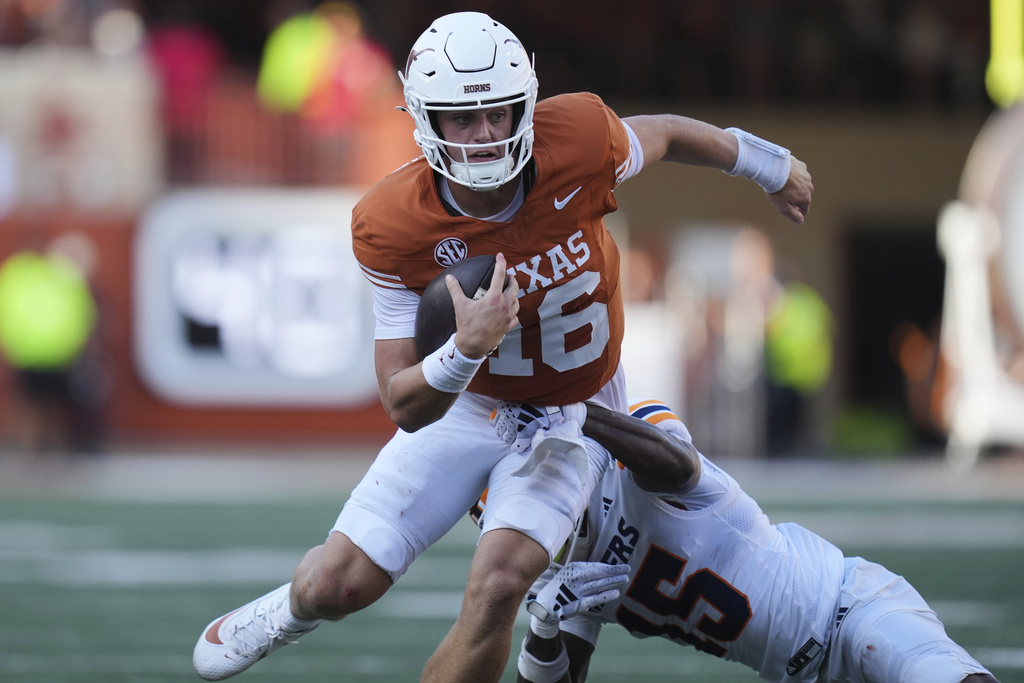 Texas quarterback Arch Manning (16) is hit by UTEP safety Kode Lowe (15) as he scrambles during the second half of an NCAA college football game in Austin, Texas, Saturday, Sept. 13, 2025. (AP Photo/Eric Gay)
