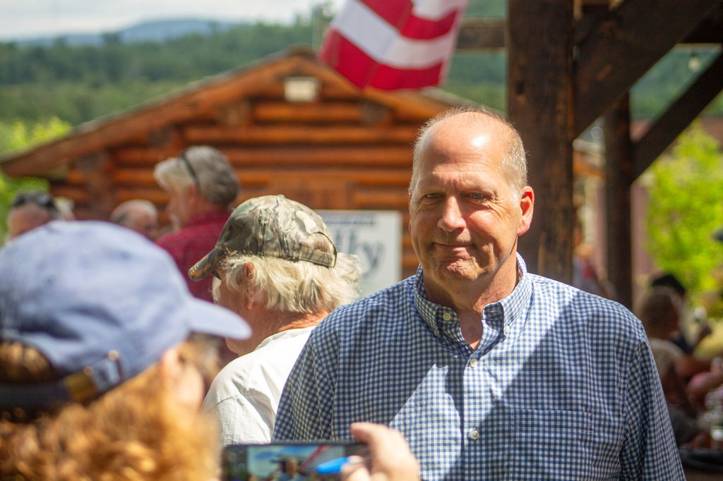 A supporter snaps a photo of former Sen. John E. Sununu as he campaigns for the GOP nomination for his old seat in Berlin, N.H., Saturday, Aug. 22, 2026. (AP Photo/Holly Ramer)
