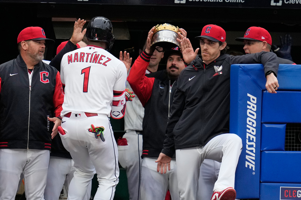 Cleveland Guardians 'Angel Martínez (1) is greeted in the dugout after hitting a solo home run in the third inning of a baseball game against the Los Angeles Angels in Cleveland, Tuesday, May 12, 2026. (AP Photo/Sue Ogrocki)