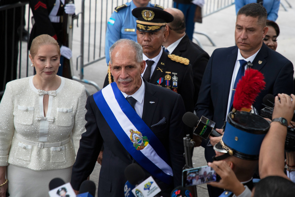 Honduran President Nasry Asfura wears the presidential sash as he walks with his wife, first lady Lissette del Cid, after his inauguration ceremony as they leave Congress in Tegucigalpa, Honduras, Tuesday, Jan. 27, 2026. (AP Photo/Fernando Destephen)