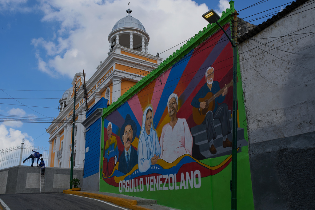 A mural features Venezuelans Jose Gregorio Hernandez, the late physician known as the "doctor of the poor", second from left, and the late Maria Carmen Rendiles, third from right, in Caracas, Venezuela, Friday, Oct 17, 2025, both of whom will be canonized as Venezuela's first saints. (AP Photo/Ariana Cubillos)