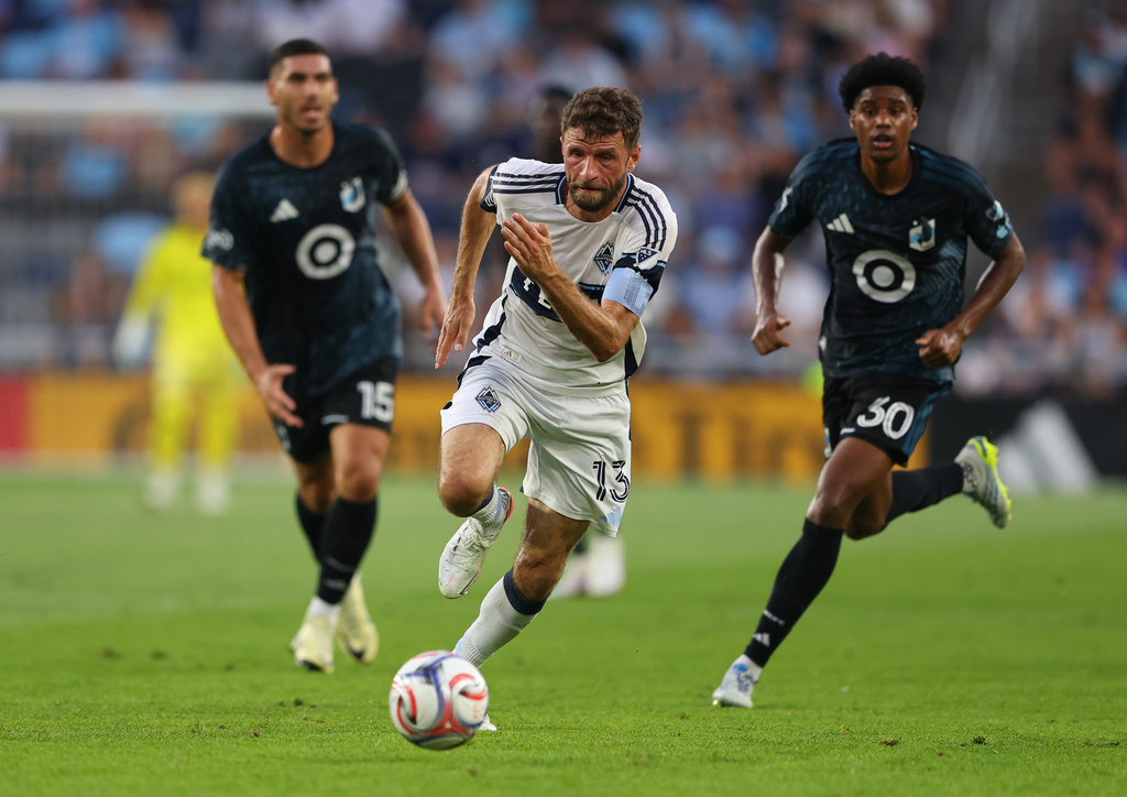 Vancouver Whitecaps FC midfield Thomas Müller (13) brings the ball up the field during the first half of an MLS soccer match on Saturday, July 25, 2026, in St. Paul, Minn. (AP Photo/Adam Bettcher)
