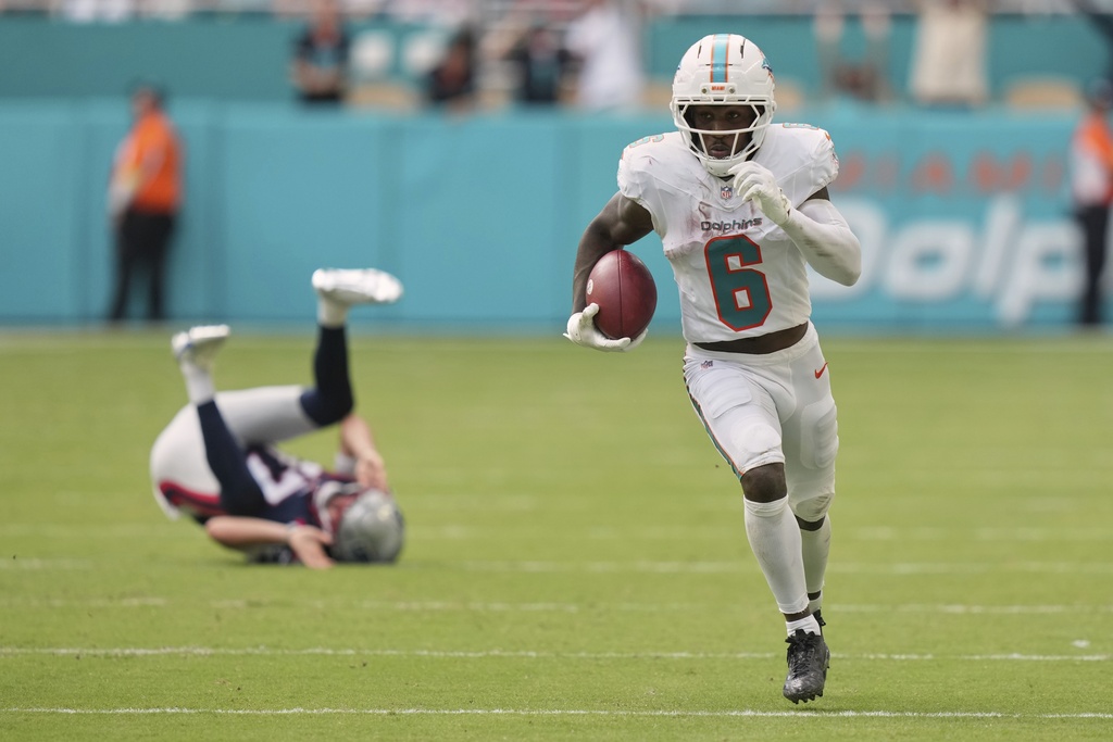 Miami Dolphins' Malik Washington gets past New England Patriots punter Bryce Baringer for a touchdown on a punt return during the second half of an NFL football game Sunday, Sept. 14, 2025, in Miami Gardens, Fla. (AP Photo/Lynne Sladky)