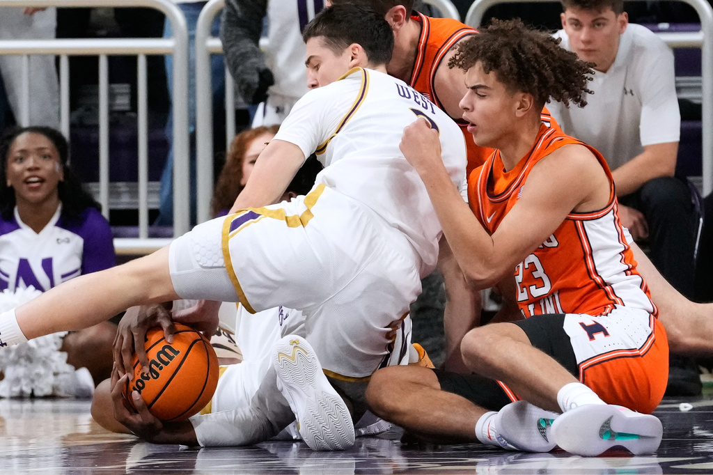 Northwestern forward Arrinten Page (22) battles for a loose ball against guard Jake West (3) and Illinois guard Keaton Wagler (23) during the first half of an NCAA college basketball game in Evanston, Ill., Wednesday, Jan. 14, 2026. (AP Photo/Nam Y. Huh)