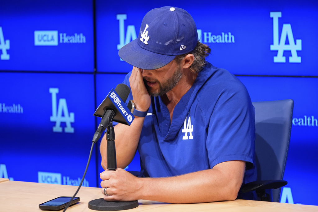 Los Angeles Dodgers pitcher Clayton Kershaw wipes his face as he speaks to the media after announcing his retirement at the end of the season prior to a baseball game against the Philadelphia Phillies Thursday, Sept. 18, 2025, in Los Angeles. (AP Photo/Mark J. Terrill)