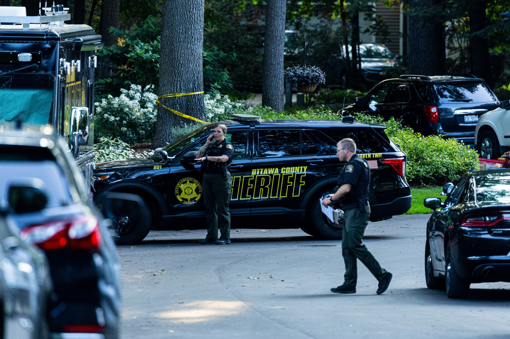Law enforcement investigate the scene of a fatal house fire on Friday, July 24, 2026, in the in Grand Haven Township, Mich. Ottawa County Sheriff's Office said six children and two adults were found dead in a "suspicious" house fire. (Joel Bissell/Kalamazoo Gazette via AP)