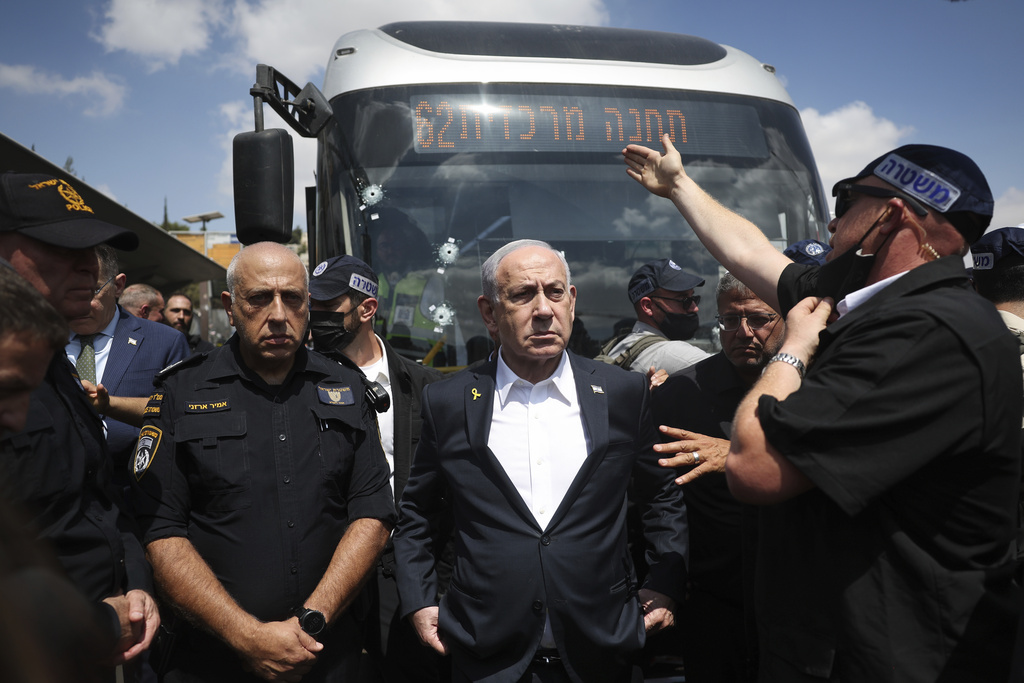 Israel's Prime Minister Benjamin Netanyahu visits the site of a shooting attack at a bus stop in Jerusalem, Monday, Sept. 8, 2025. (Ronen Zvulun/Pool Photo via AP)