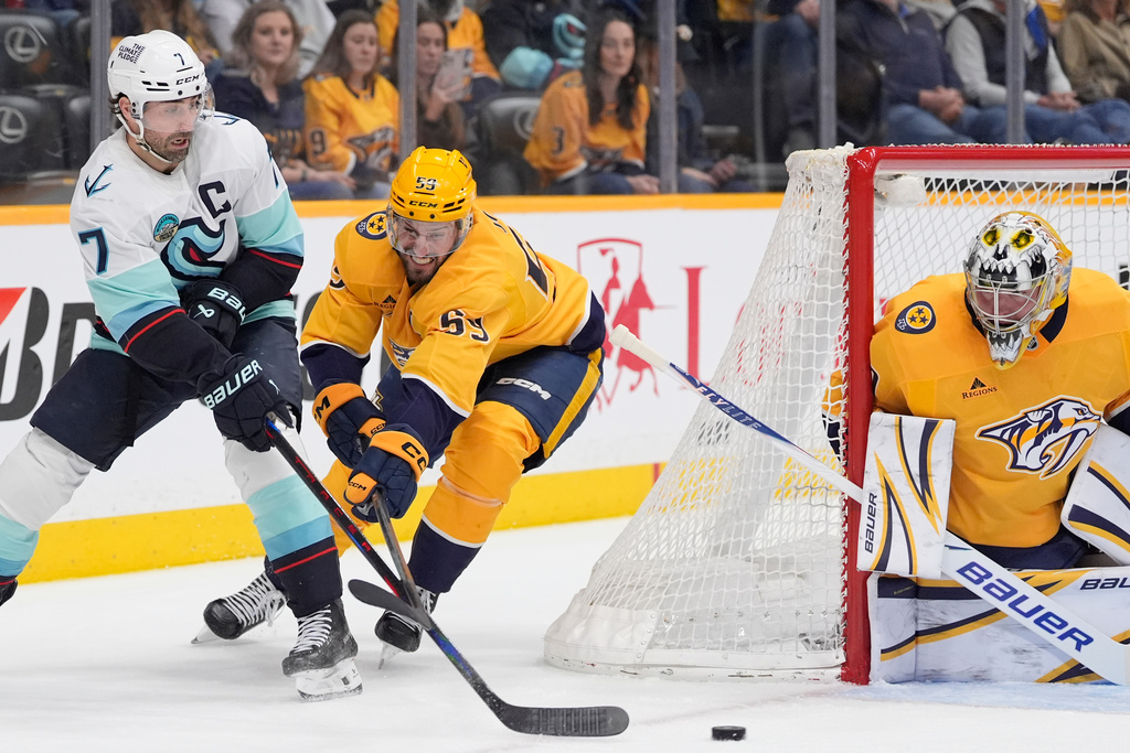 Seattle Kraken right wing Jordan Eberle (7) shoots the puck past Nashville Predators defenseman Roman Josi (59) during the first period of an NHL hockey game Thursday, March 19, 2026, in Nashville, Tenn. (AP Photo/George Walker IV)