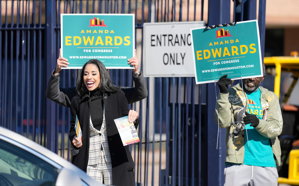Texas Congressional Candidate Amanda Edwards waves at a voter at a polling location at Acres Homes MultiService Center on Election Day, in Houston, Saturday, Jan. 31, 2026. (AP Photo/ Karen Warren)
