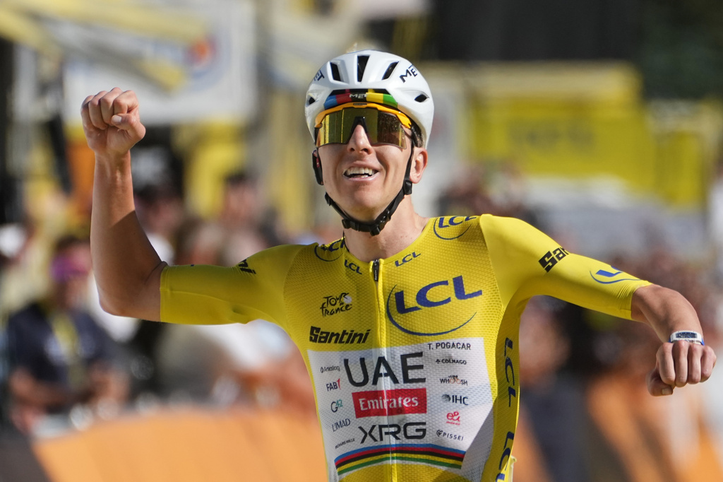 Slovenia's Tadej Pogacar, wearing the overall leader's yellow jersey, reacts as he crosses the finish line to win the nineteenth stage of the Tour de France cycling race with start in Gap and finish in Alpe d'Huez, France, Friday, July 24, 2026. (AP Photo/Thibault Camus)