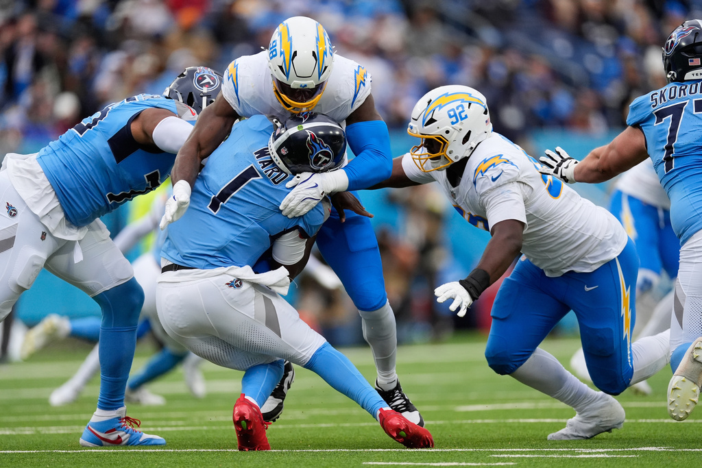 Tennessee Titans quarterback Cam Ward (1) is sacked by Los Angeles Chargers linebacker Odafe Oweh (98) during the second half of an NFL football game Sunday, Nov. 2, 2025, in Nashville, Tenn. (AP Photo/George Walker IV)