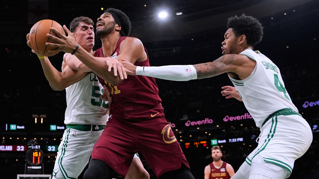 Cleveland Cavaliers center Jarrett Allen, center, tries to drive to the basket against Boston Celtics center Luka Garza (52) and guard Anfernee Simons (4) during the first half of an NBA basketball game, Wednesday, Oct. 29, 2025, in Boston. (AP Photo/Charles Krupa)