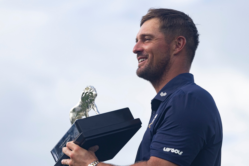 First-place individual champion, captain Bryson DeChambeau, of Crushers GC, poses for a photo with the trophy after the final round of LIV Golf South Africa at The Club at Steyn City, Sunday, March 22, 2026, in Midrand, South Africa. (LIV Golf via AP)