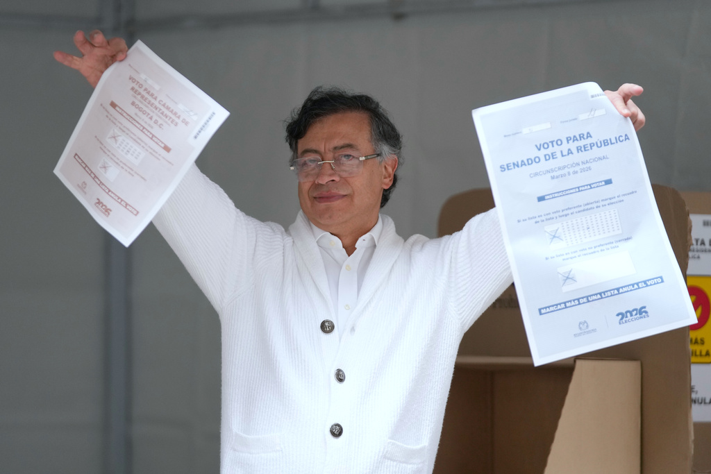 Colombia's President Gustavo Petro shows the ballots before voting in legislative elections in Bogota, Colombia, Sunday, March 8, 2026. (AP Photo/Fernando Vergara)