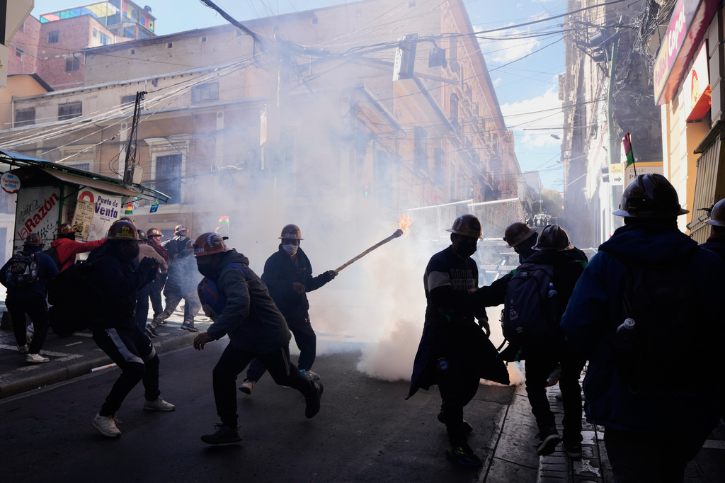 Artisanal miners clash with police during a protest demanding access to expanded mining areas in La Paz, Bolivia, Thursday, May 14, 2026. (AP Photo/Juan Karita)