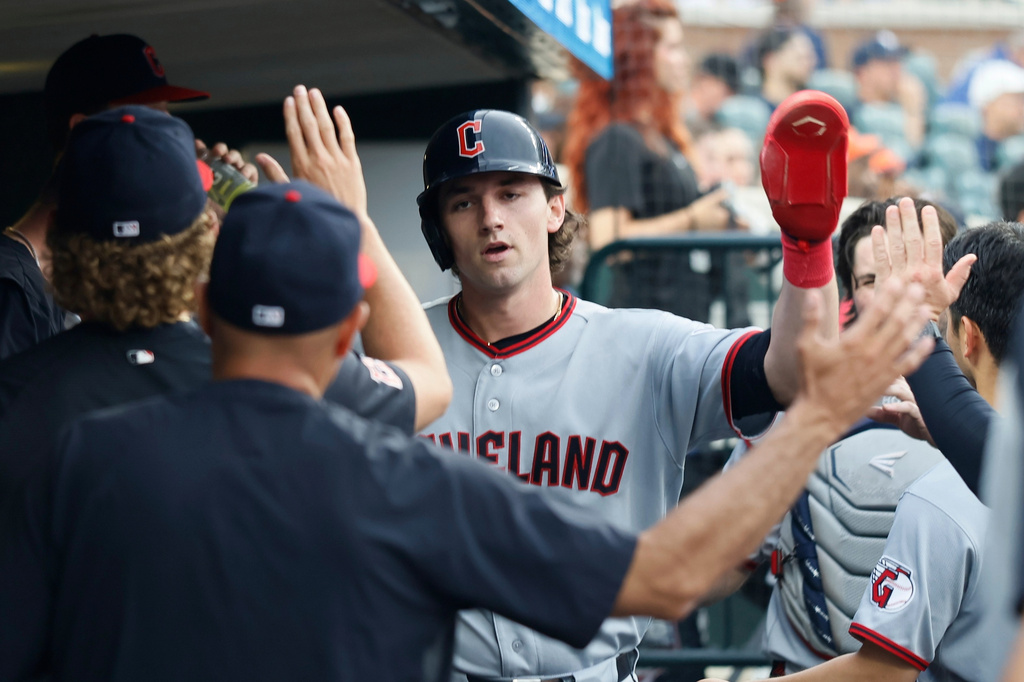 Cleveland Guardians' Chase DeLauter, center, celebrates in the dugout after scoring against the Detroit Tigers on a double hit by Rhys Hoskins during the third inning of a baseball game Monday, May 18, 2026, in Detroit. (AP Photo/Duane Burleson)