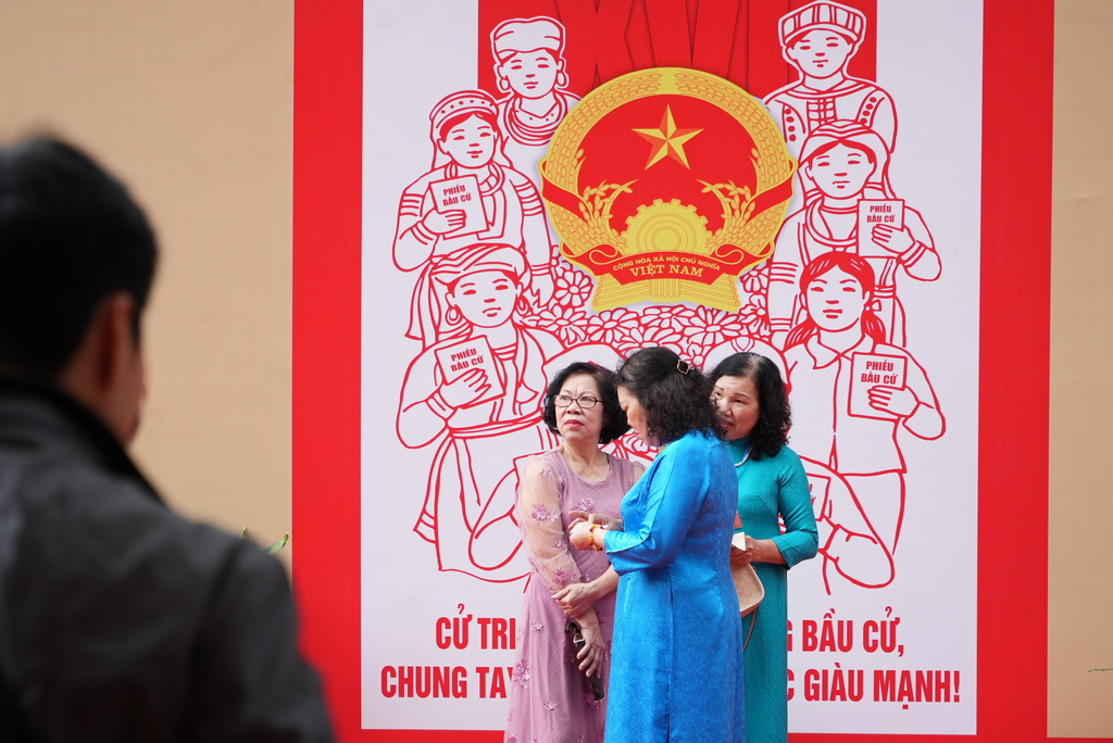 Voters wait to cast ballots to elect representatives in the National Assembly and people's councils in Hanoi, Vietnam, Sunday, March 15, 2026. (AP Photo/Hau Dinh)