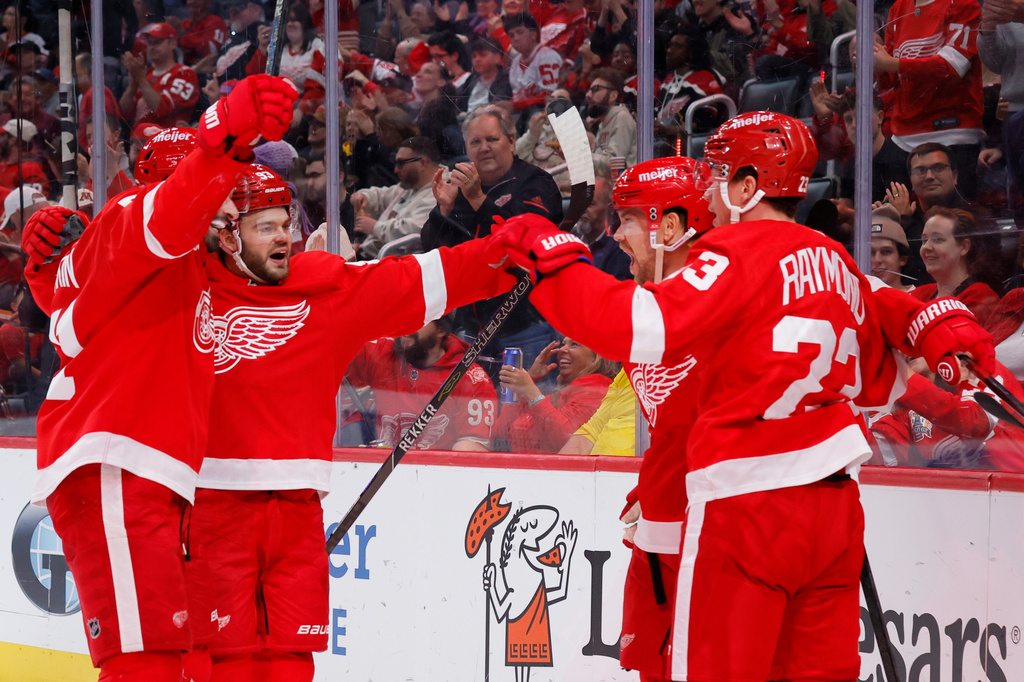 Detroit Red Wings left wing Viktor Arvidsson, second from right, celebrates with, from left, center Dylan Larkin, right wing Alex DeBrincat and left wing Lucas Raymond (23) during the second period of an NHL hockey game Tuesday, Oct. 6, 2026, in Detroit. (AP Photo/Duane Burleson)