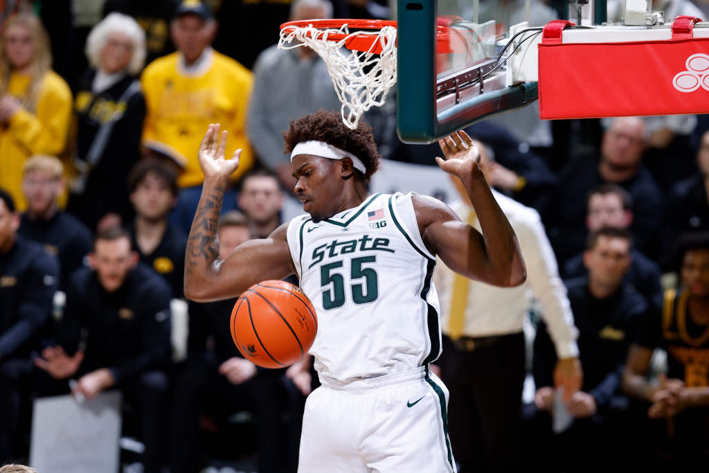Michigan State forward Coen Carr (55) dunks during the first half of an NCAA college basketball game against Iowa, Tuesday, Dec. 2, 2025, in East Lansing, Mich. (AP Photo/Al Goldis)