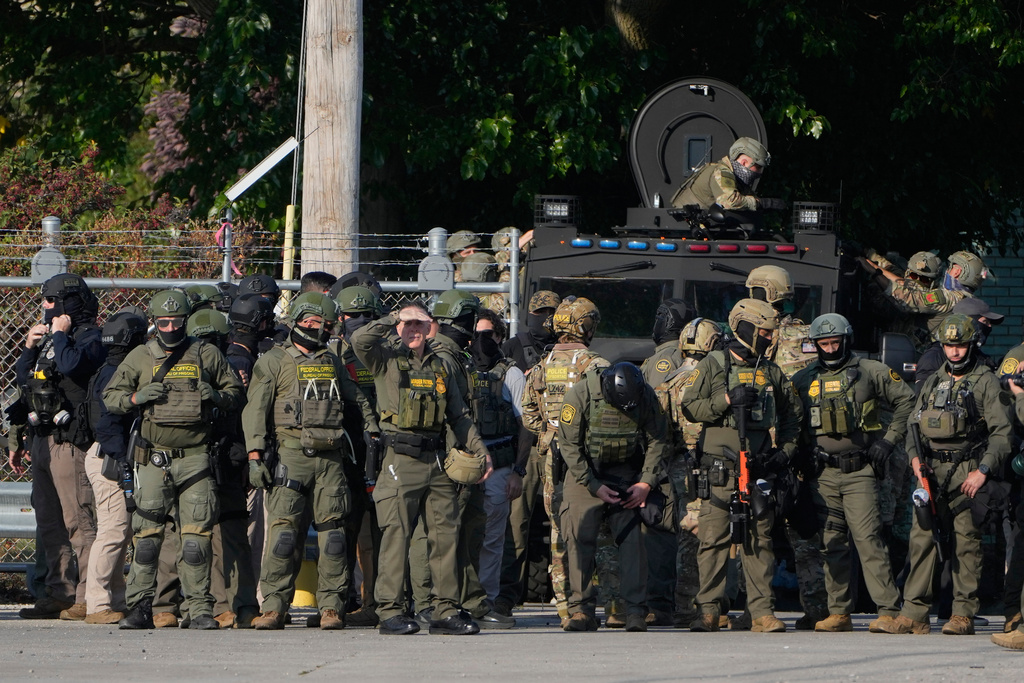 Greg Bovino, the chief patrol agent for the U.S. Border Patrol El Centro sector, center, stands with federal immigration agents near an Immigration and Customs Enforcement facility in Broadview, Ill., Friday, Oct. 3, 2025. (AP Photo/Erin Hooley)