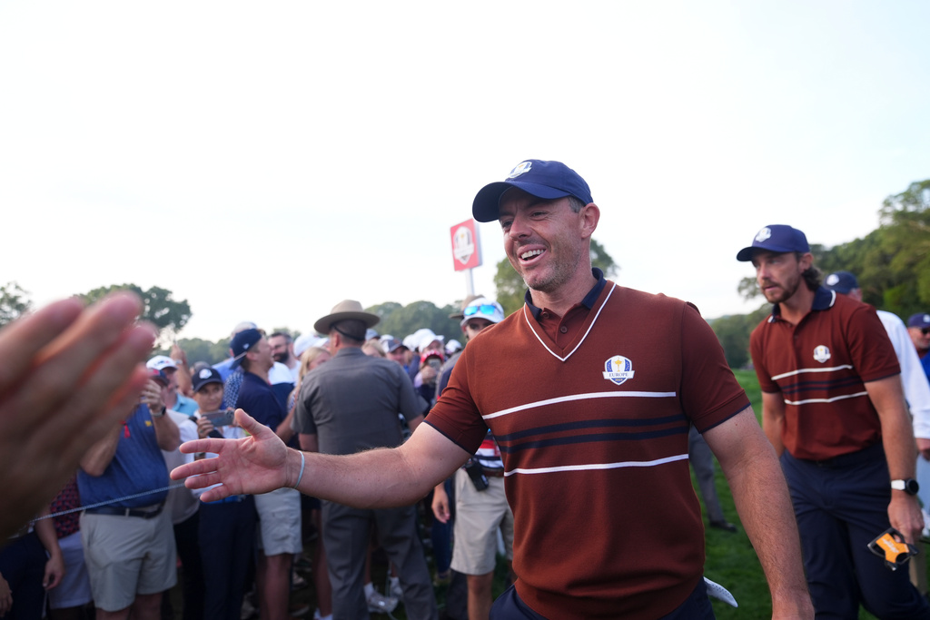 Europe's Rory McIlroy greets a fan on the second hole at Bethpage Black golf course during the Ryder Cup golf tournament, Saturday, Sept. 27, 2025, in Farmingdale, N.Y. (AP Photo/Lindsey Wasson)