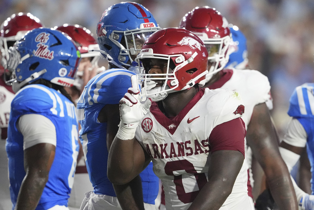 Arkansas running back Braylen Russell (0) gestures after scoring a three-yard touchdown against Mississippi during the first half of an NCAA college football game in Oxford, Miss., Saturday, Sept. 13, 2025. (AP Photo/Rogelio V. Solis)