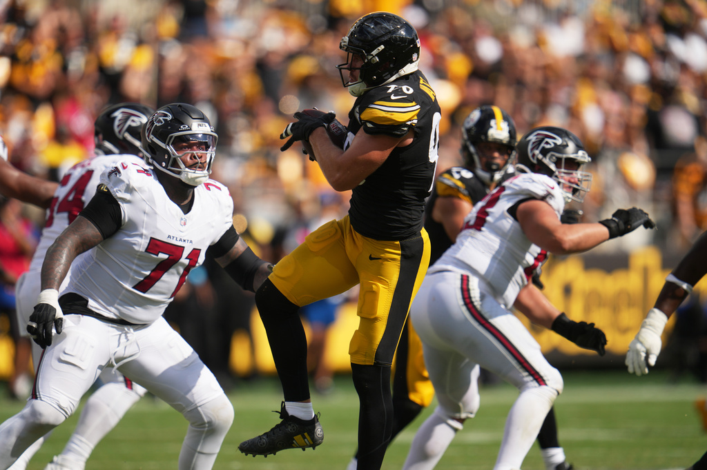 Pittsburgh Steelers outside linebacker T.J. Watt (90) intercepts a pass made by Atlanta Falcons quarterback Cooper Rush (13) during an NFL football game, Sunday, Sept. 13, 2026, in Pittsburgh. (AP Photo/Gene J. Puskar)