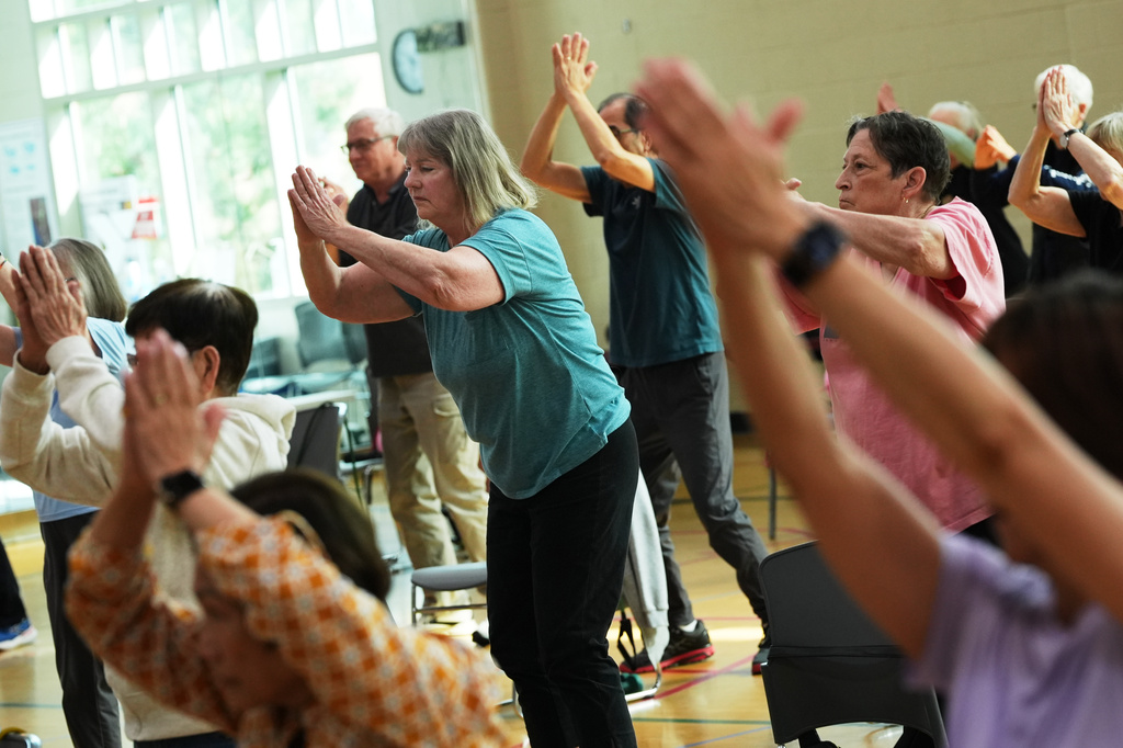 Participants do arm exercises during an exercise class for older adults led by instructor Bengie Santos, 72, at the Dale Turner Family YMCA, April 30, 2026, in Shoreline, Wash. (AP Photo/Lindsey Wasson)