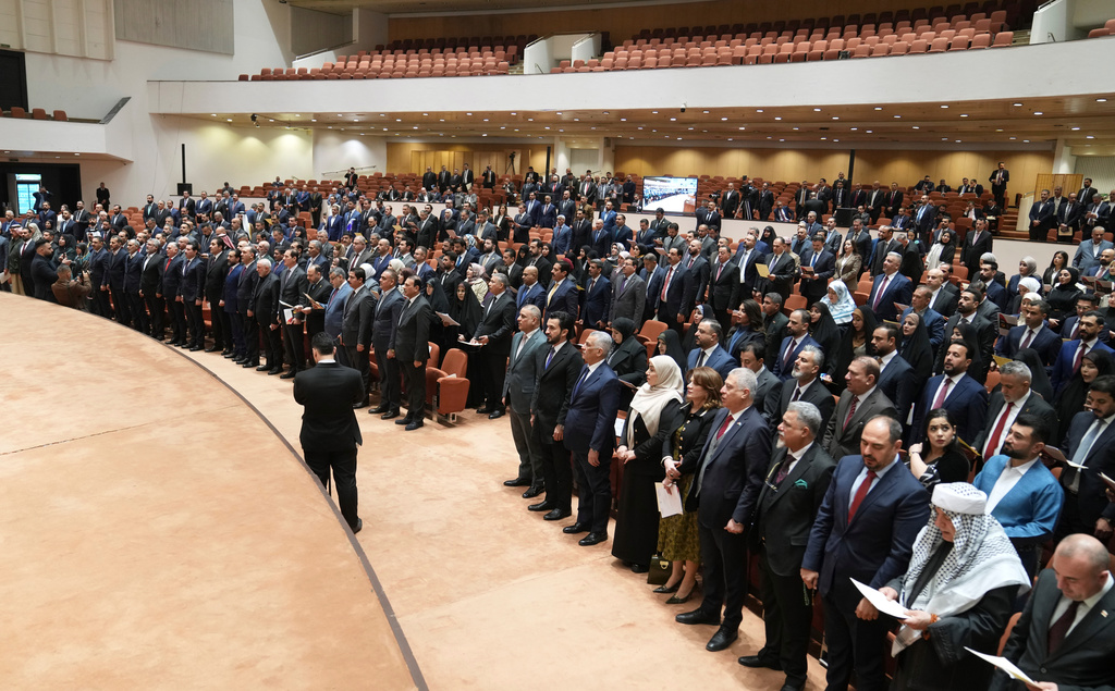 Newly elected lawmakers attend the first parliament session, in Baghdad, Iraq, Monday, Dec. 29, 2025. (Iraqi Parliament Media Office via AP)